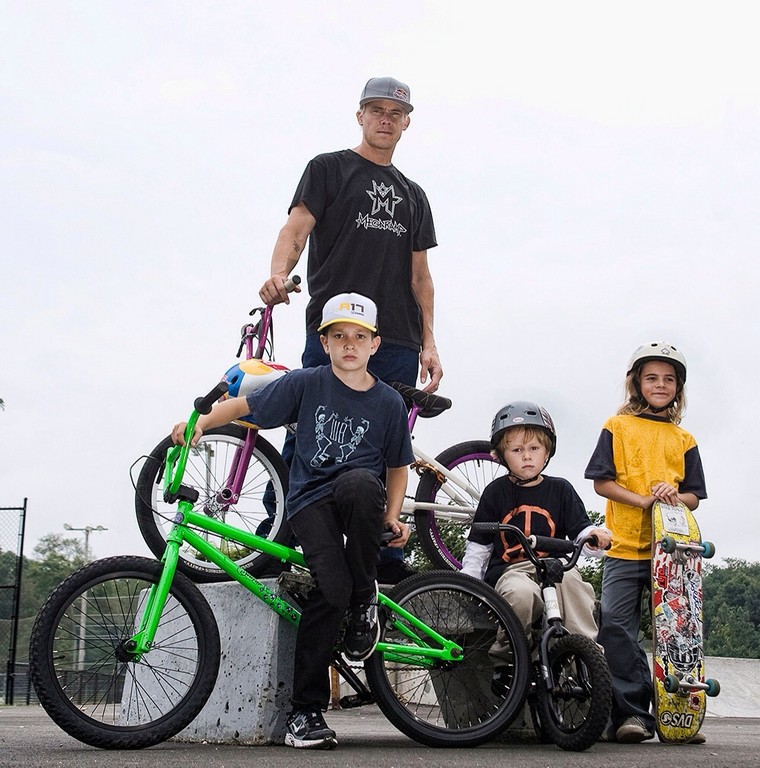 When he isn’t competing, Kevin Robinson, pictured here with his three children, works hard to promote kids’ involvement in sports through the K-Rob Foundation