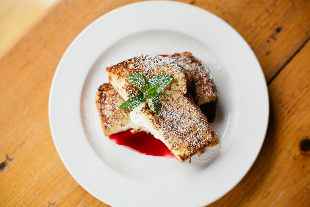Cloumage-stuffed french toast with a coconut crust and raspberry puree