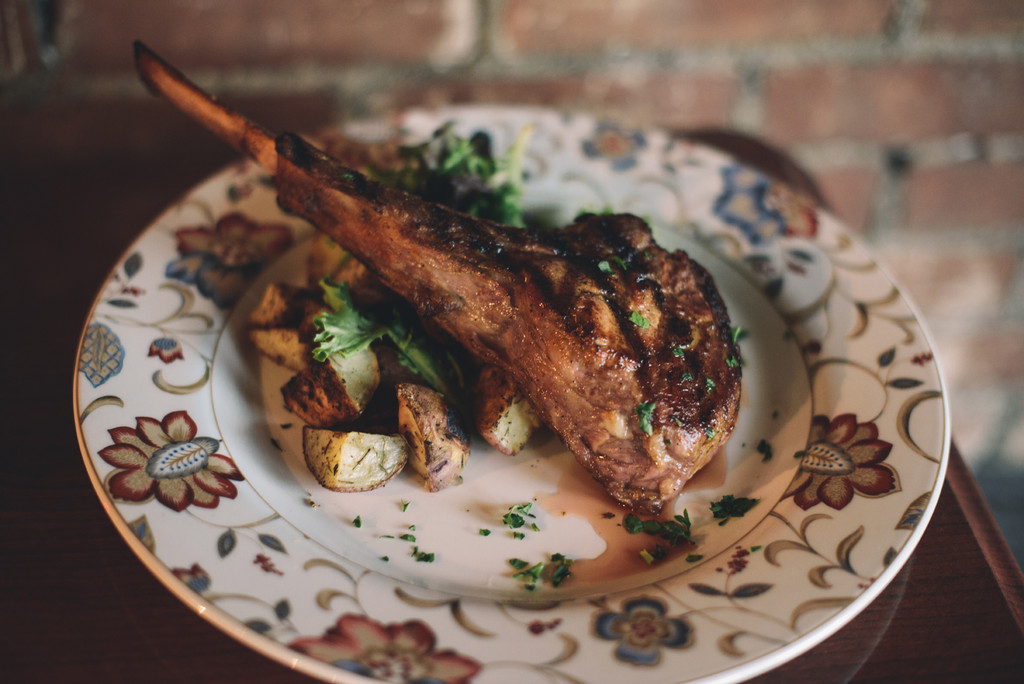 Grilled Bone in Veal Chop with red bliss potatoes and petit greens
￼