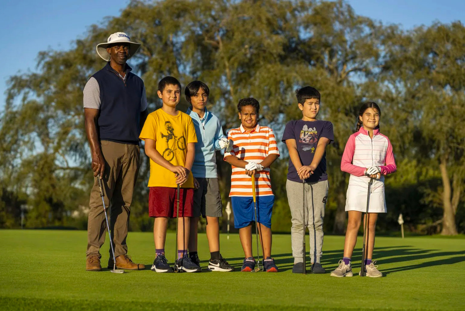 Director Orlando Peace with young FabGolf athletes