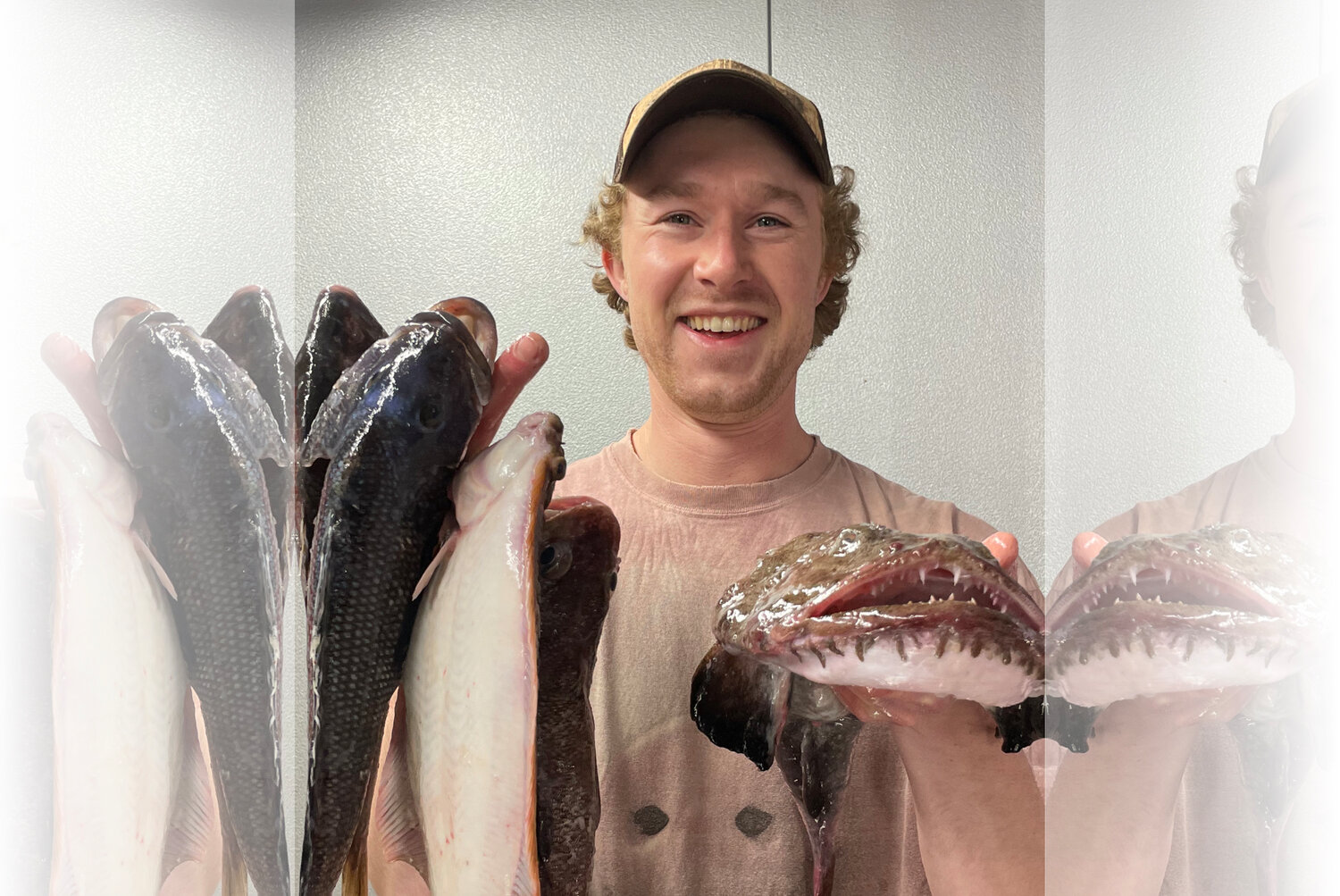 Mike Lapierre holds up a fresh catch including a jumbo scup, monkfish, and more, ready for cooking