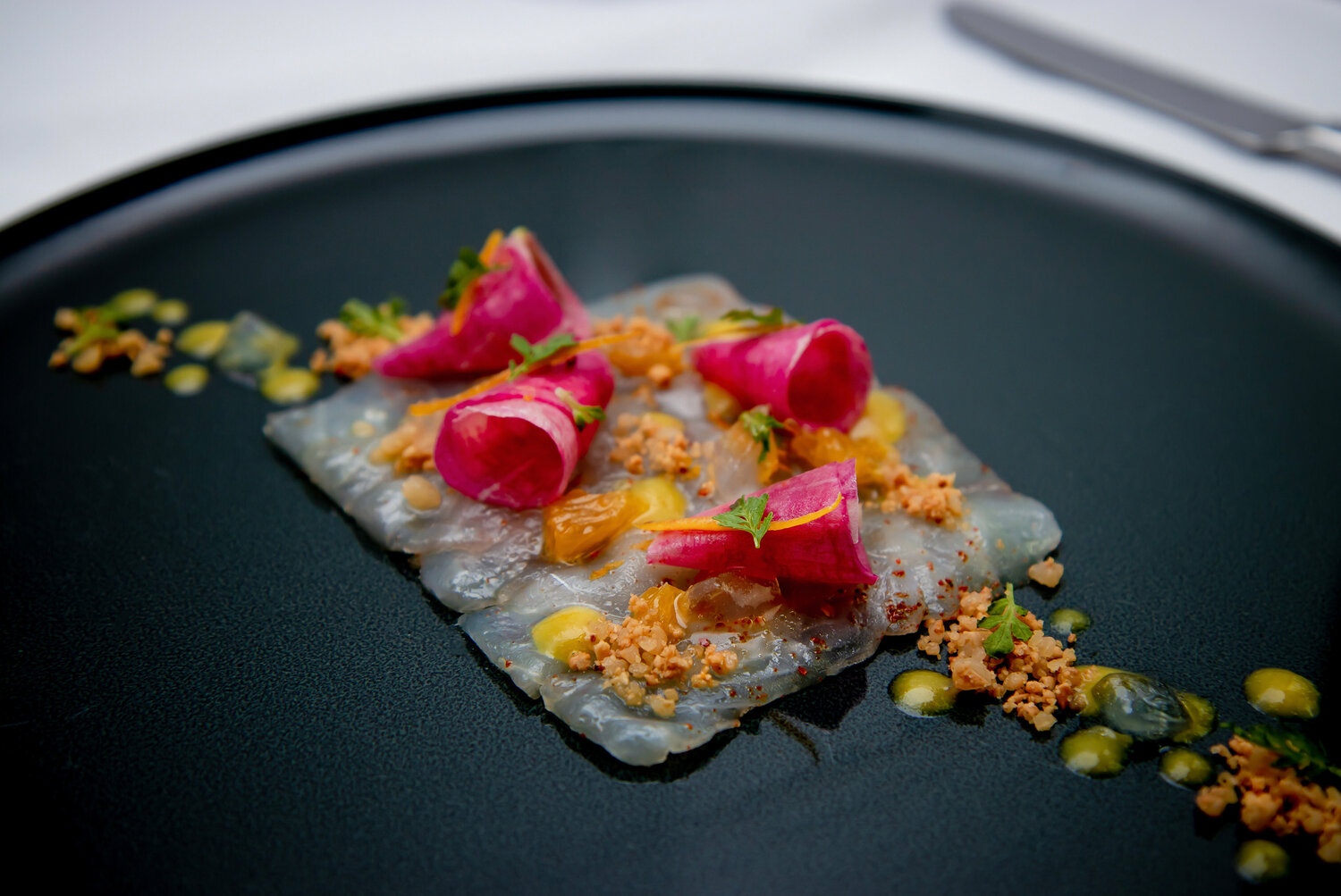 From the summer tasting menu: black sea bass with Marcona almond nougatine, radish, and citrus